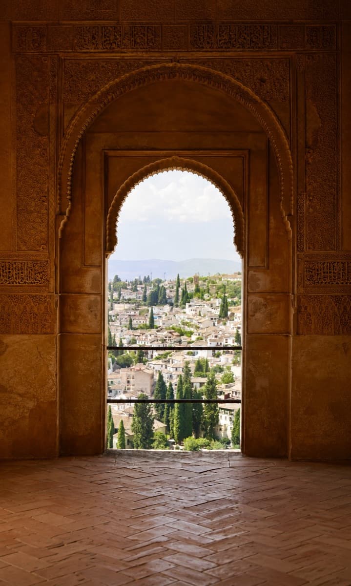 Looking out over a city through an ornate arch